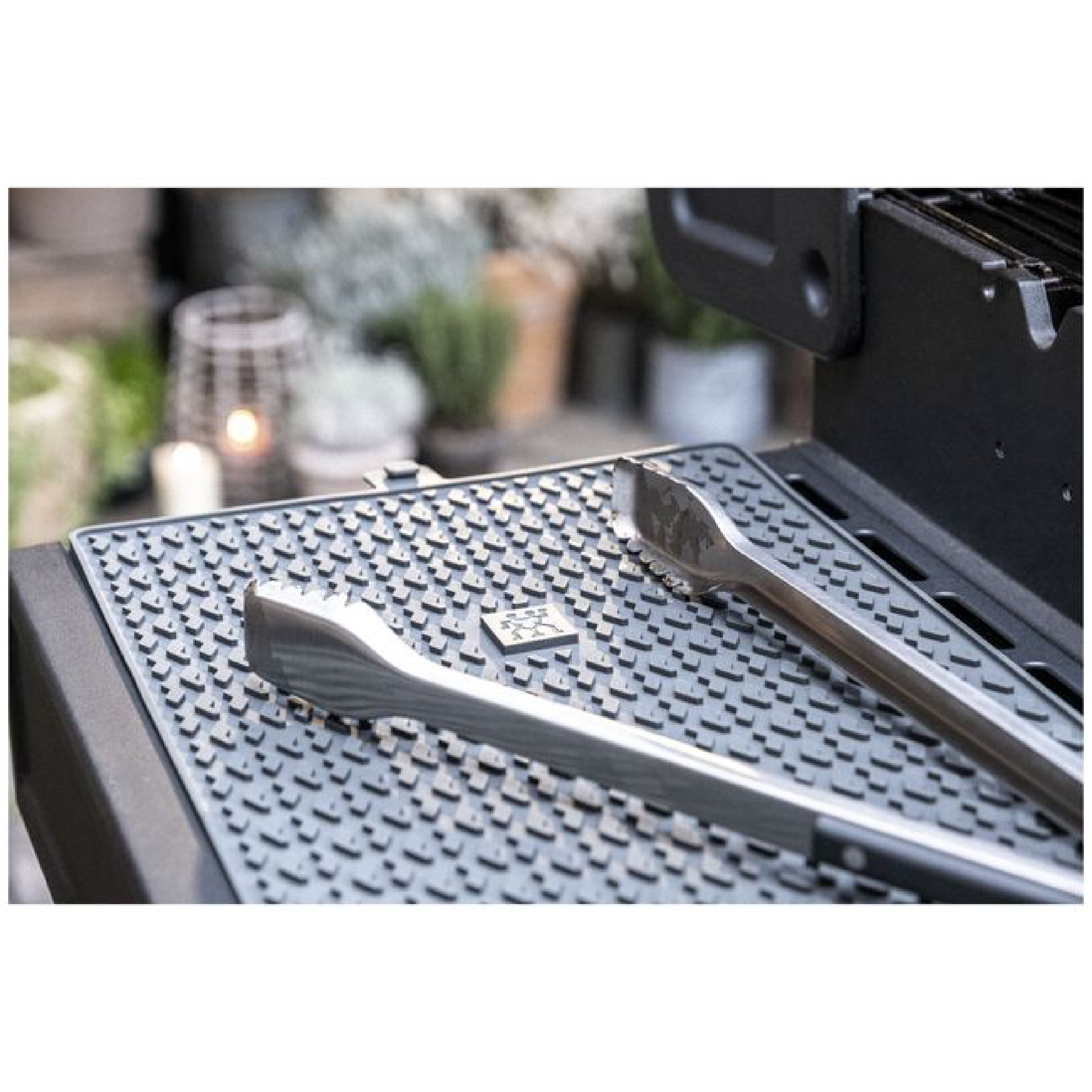 Silicone protection mat laid on grill with raised patterned texture