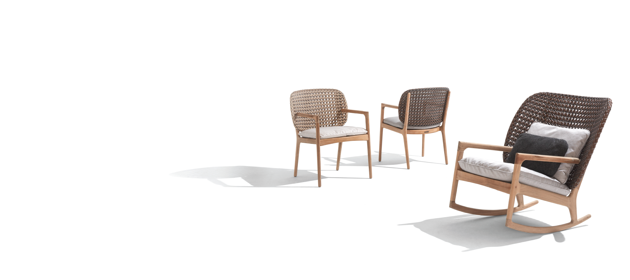 Gloster Kay rocking lounge chairs in a luxury outdoor living room setting
