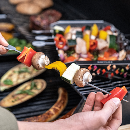 BBQ skewers with vegetables and mushrooms on a grill